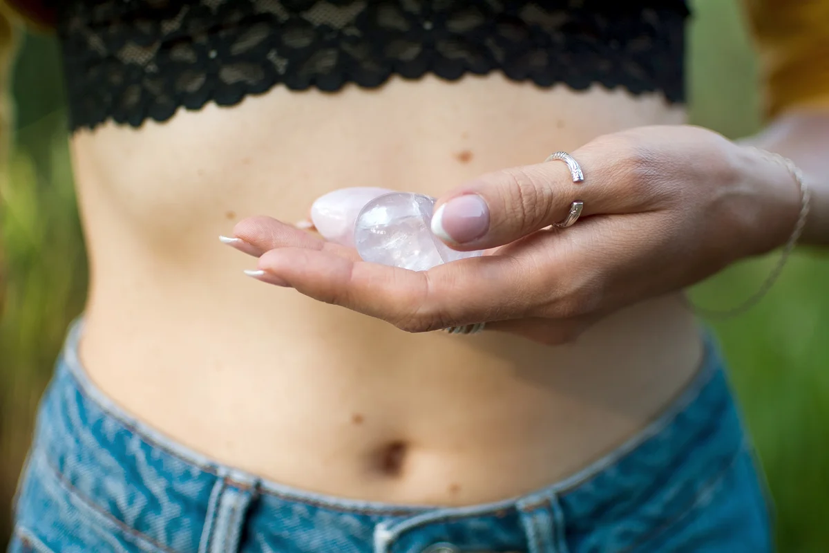 Female hands holding two worry stones
