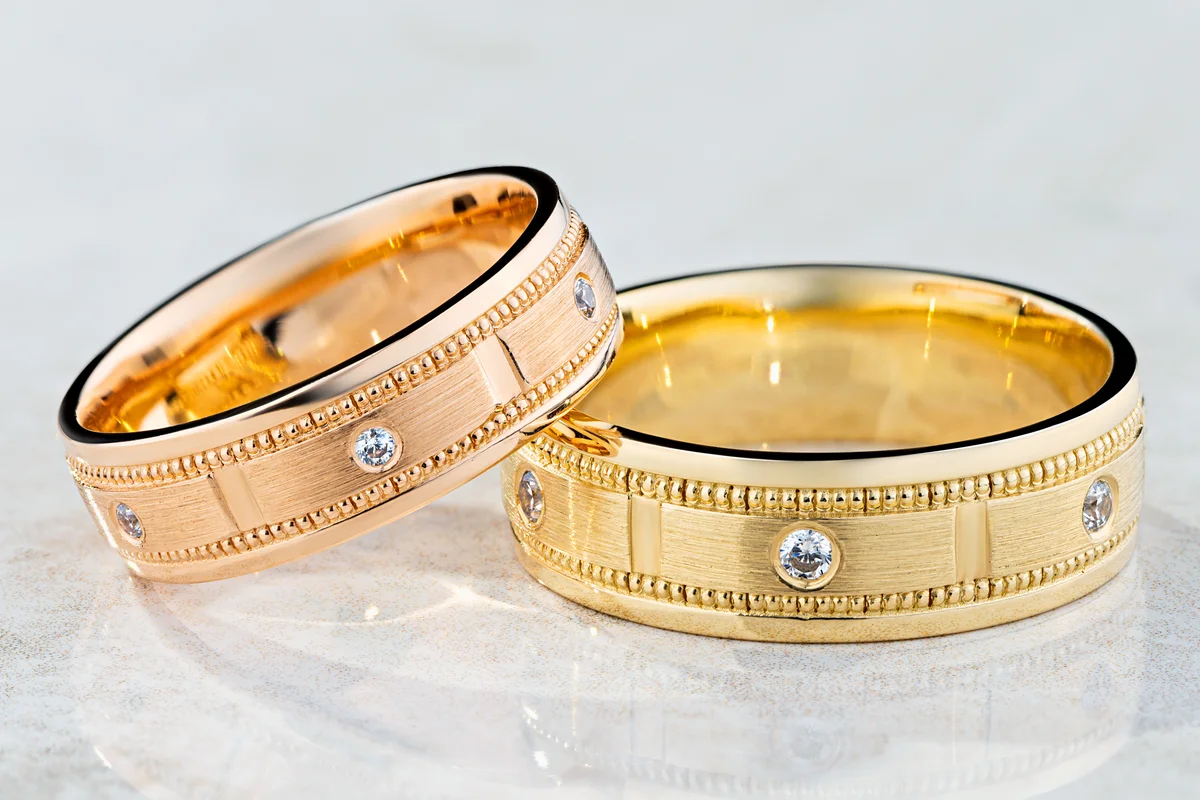 Pair of modern textured wedding rings decorated with diamonds