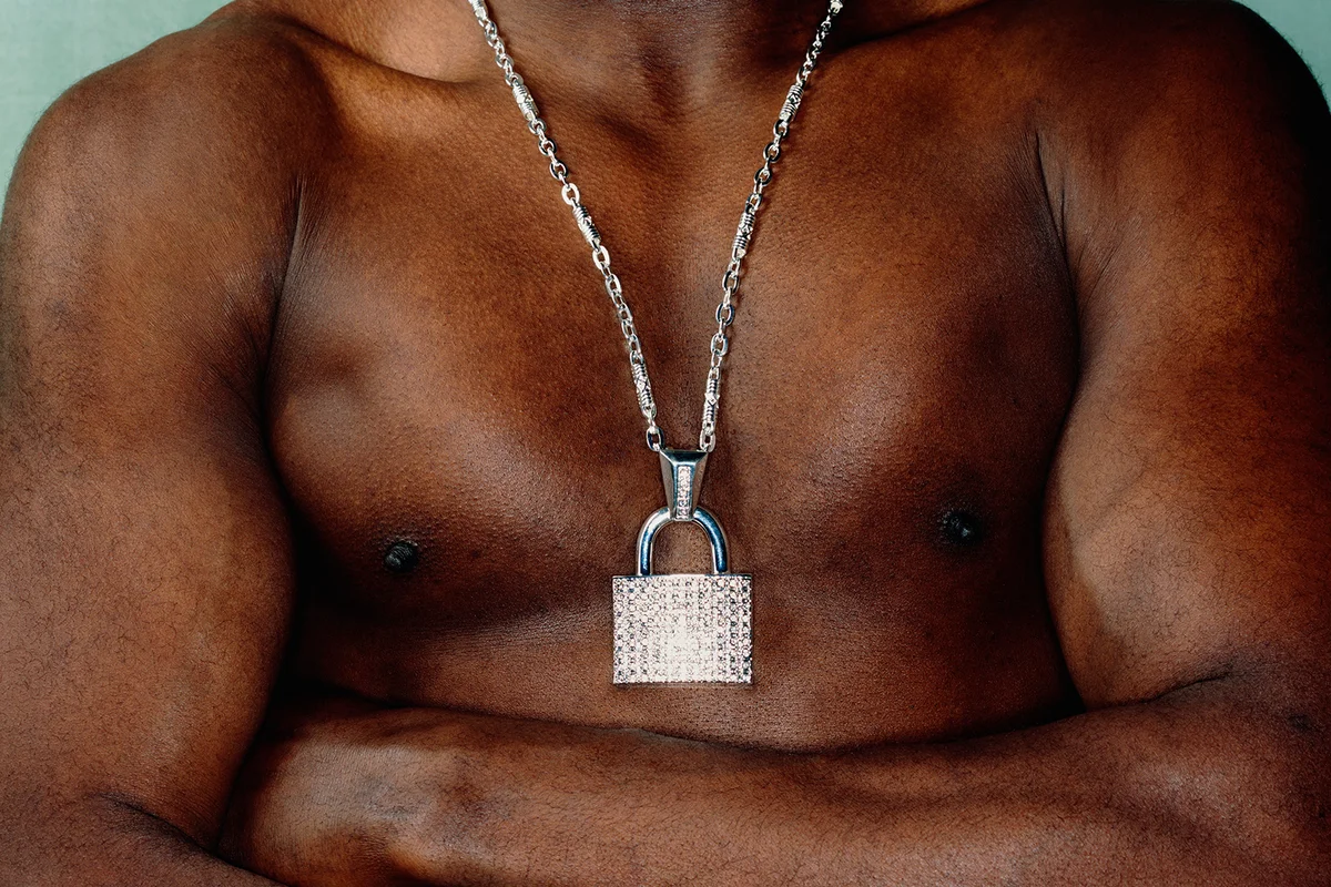 man wearing padlock around neck
