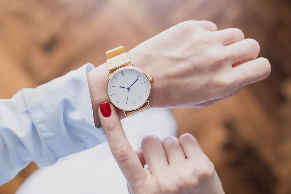 Young woman checking the time on watch