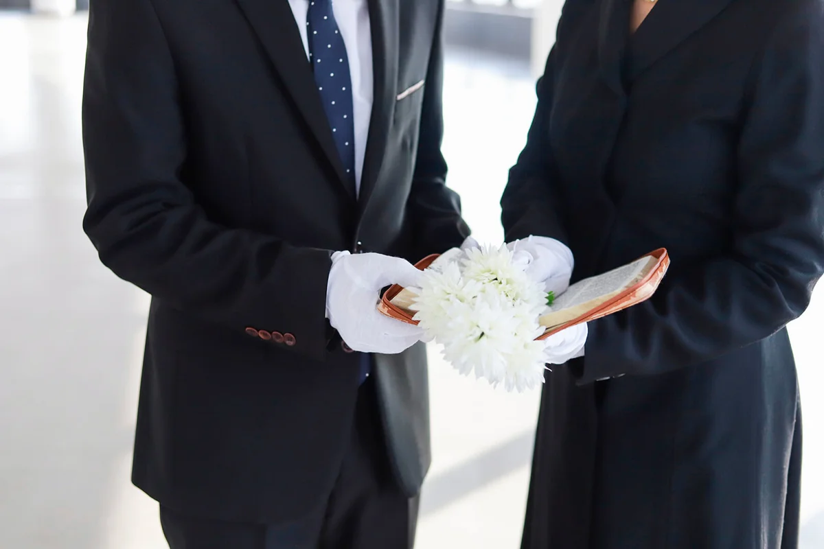 bereaved holding bible and white flower