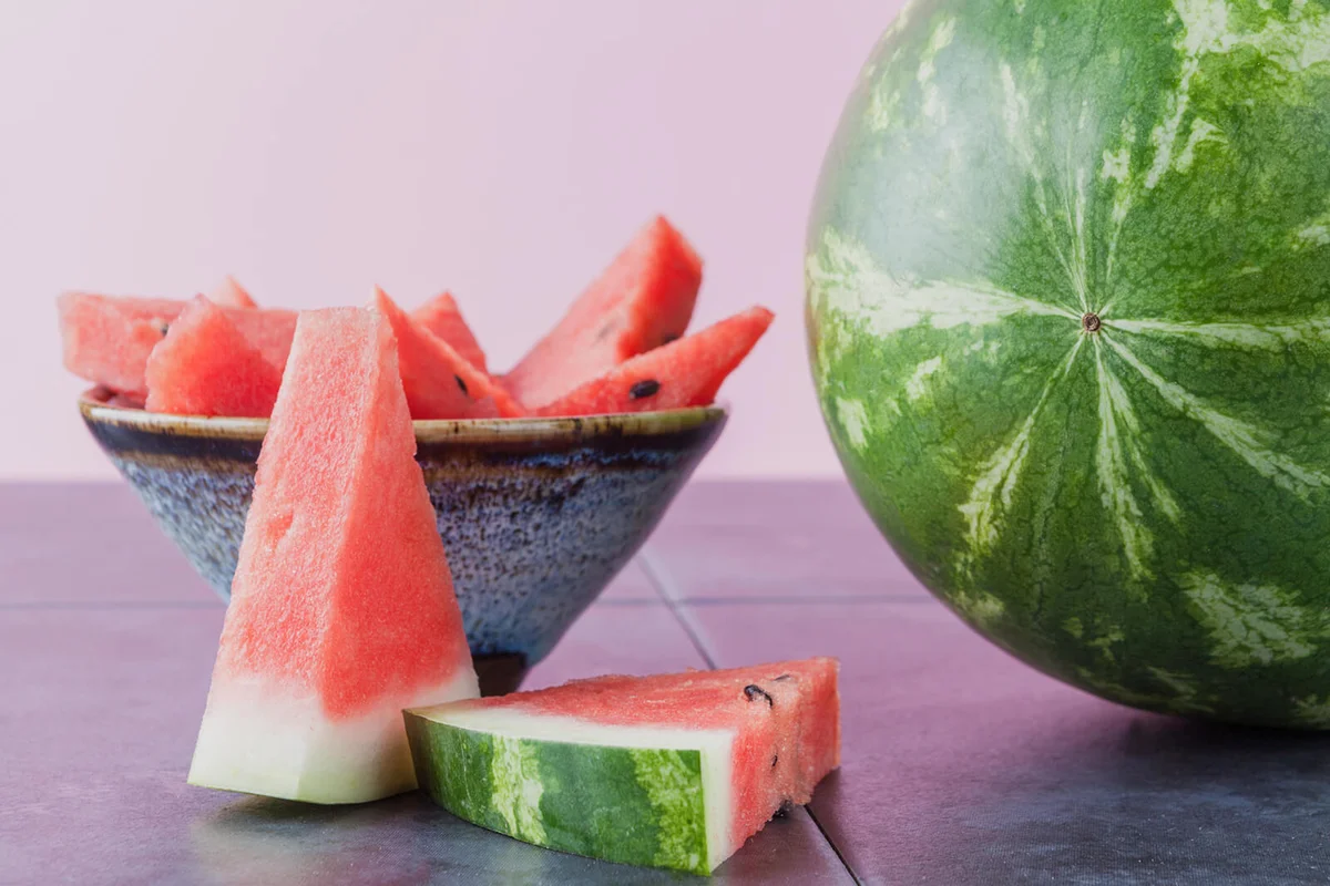 Watermelon On Table Against Purple Background