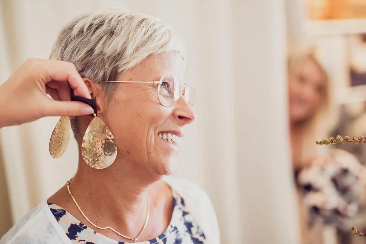 Woman trying earrings