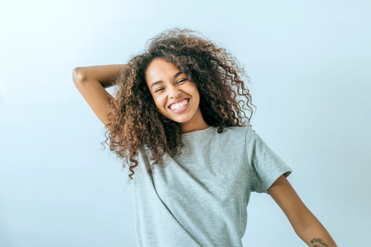 Woman with afro hair smiling