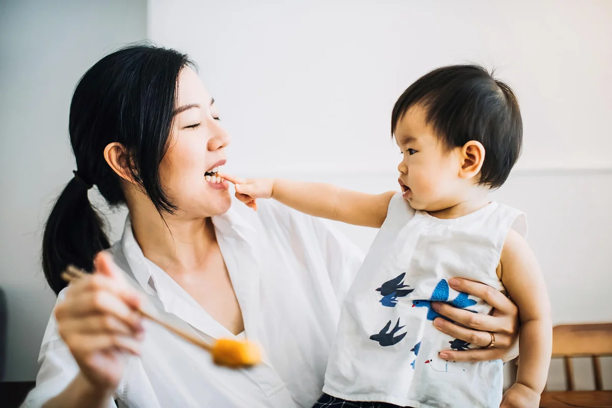 Joyful mother and baby girl having fun time