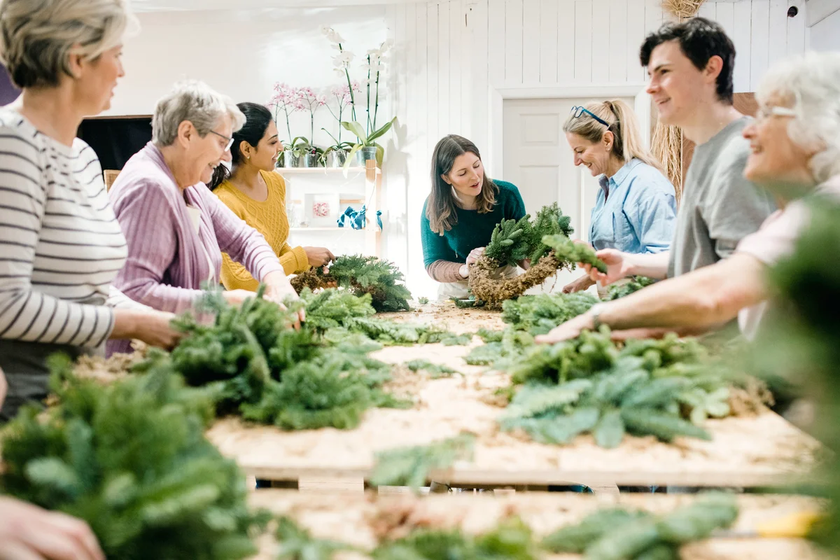 Group of people are taking part in a wreath making workshop
