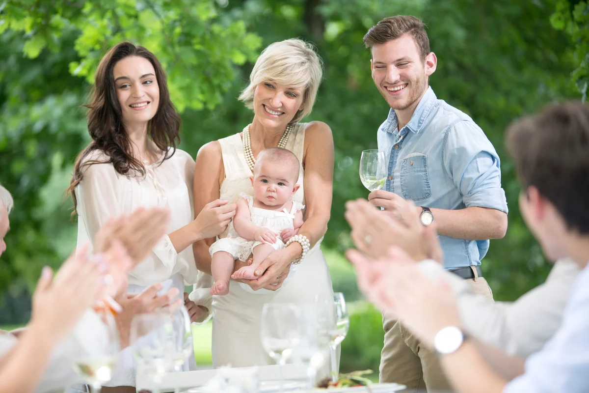 Baby being introduced to family on a garden party