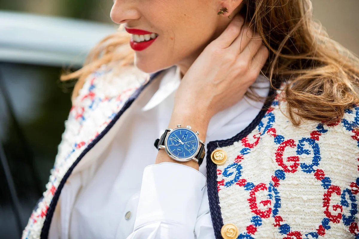 Alexandra Lapp is seen wearing a white Gucci Sylvie tweed jacket, a white Talbot Runhof cape blouse, IWC Portofino Chronograph | Getty Editorial Use
