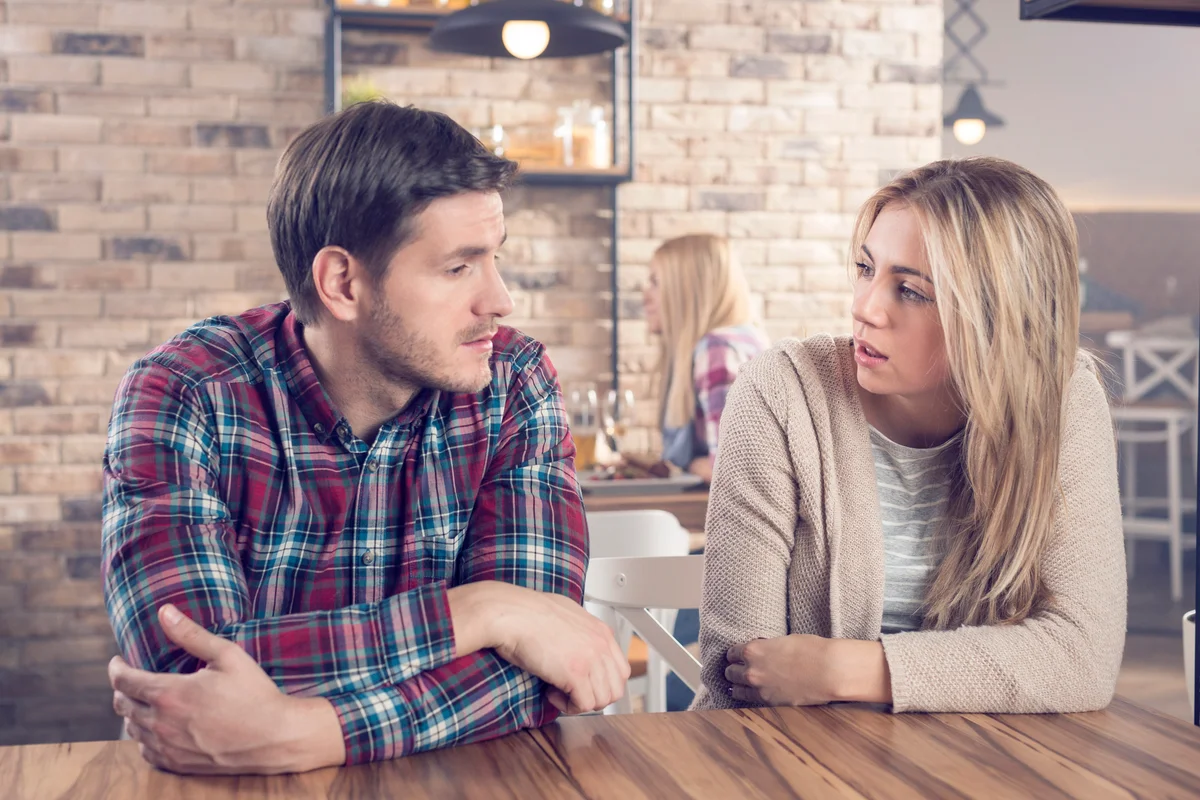 Young couple having a serious conversation in a bar