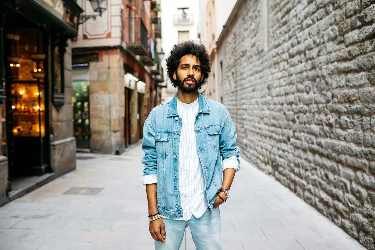 Bearded young man with curly hair in Barcelona