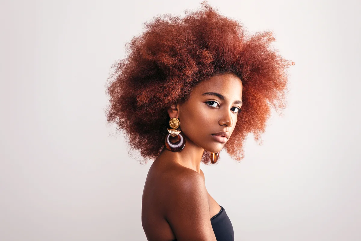 Beautiful woman with afro wearing earrings
