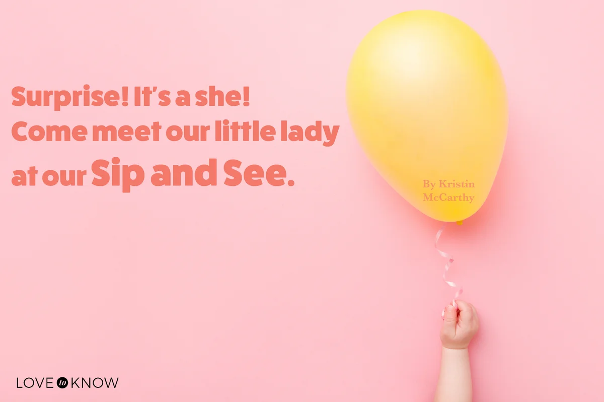 Infant hand holding one yellow balloon on pink  background