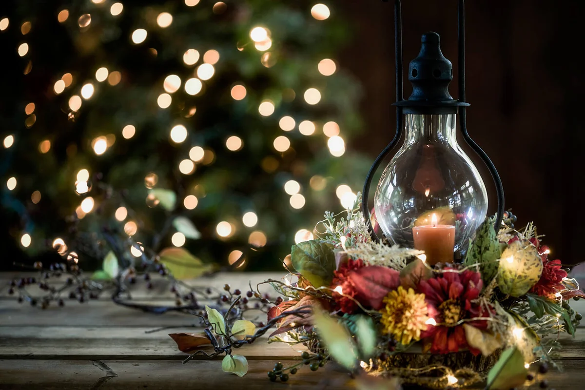 Elegant Holiday Lantern and Wreath in Front of a Christmas Tree