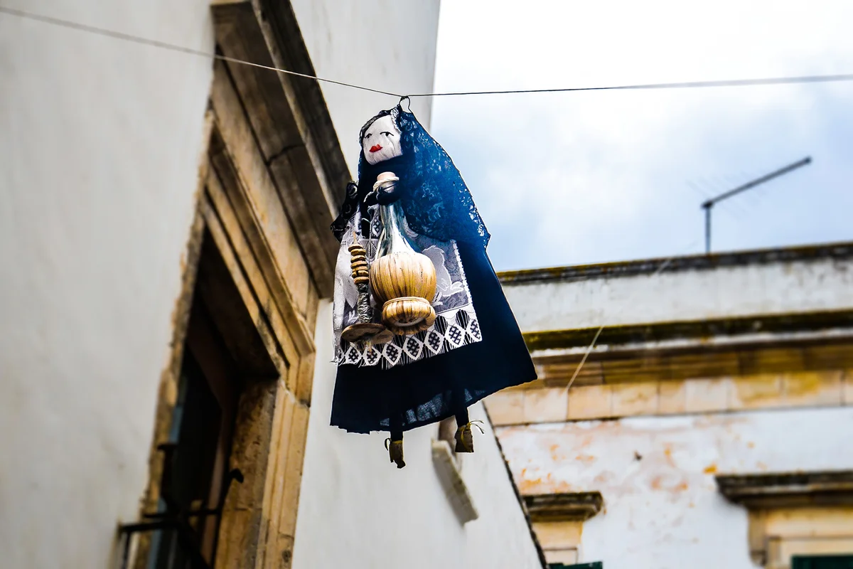 Typical Epiphany scene in Italy with a Befana hanging on a cable