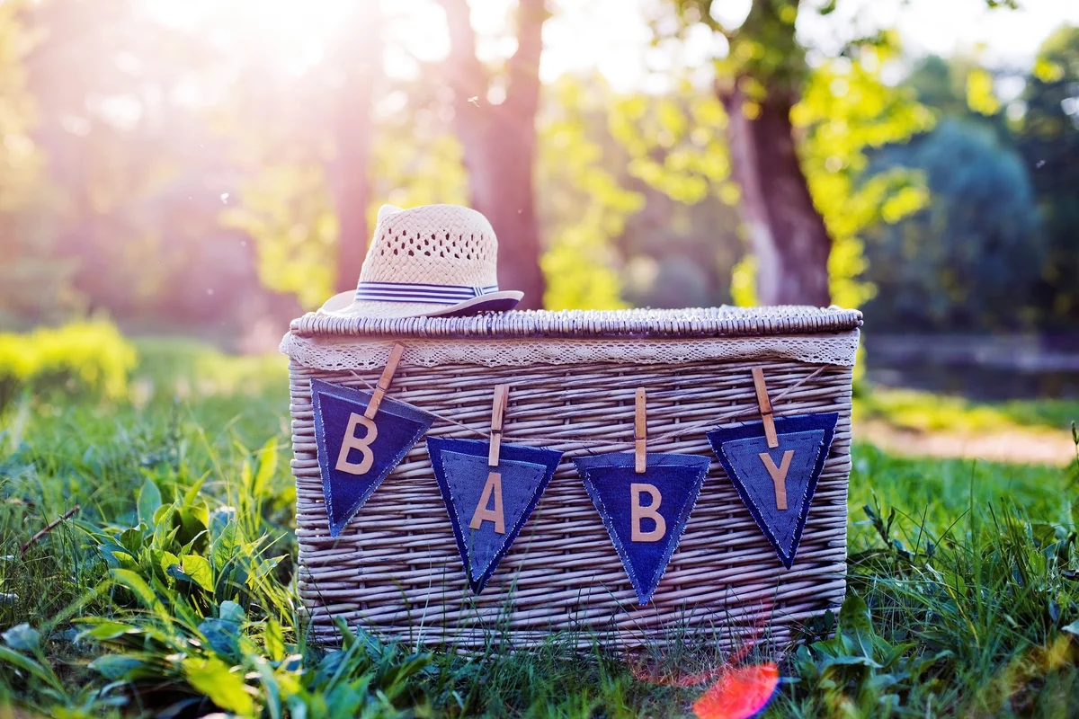 Garland with the word baby on the basket in nature