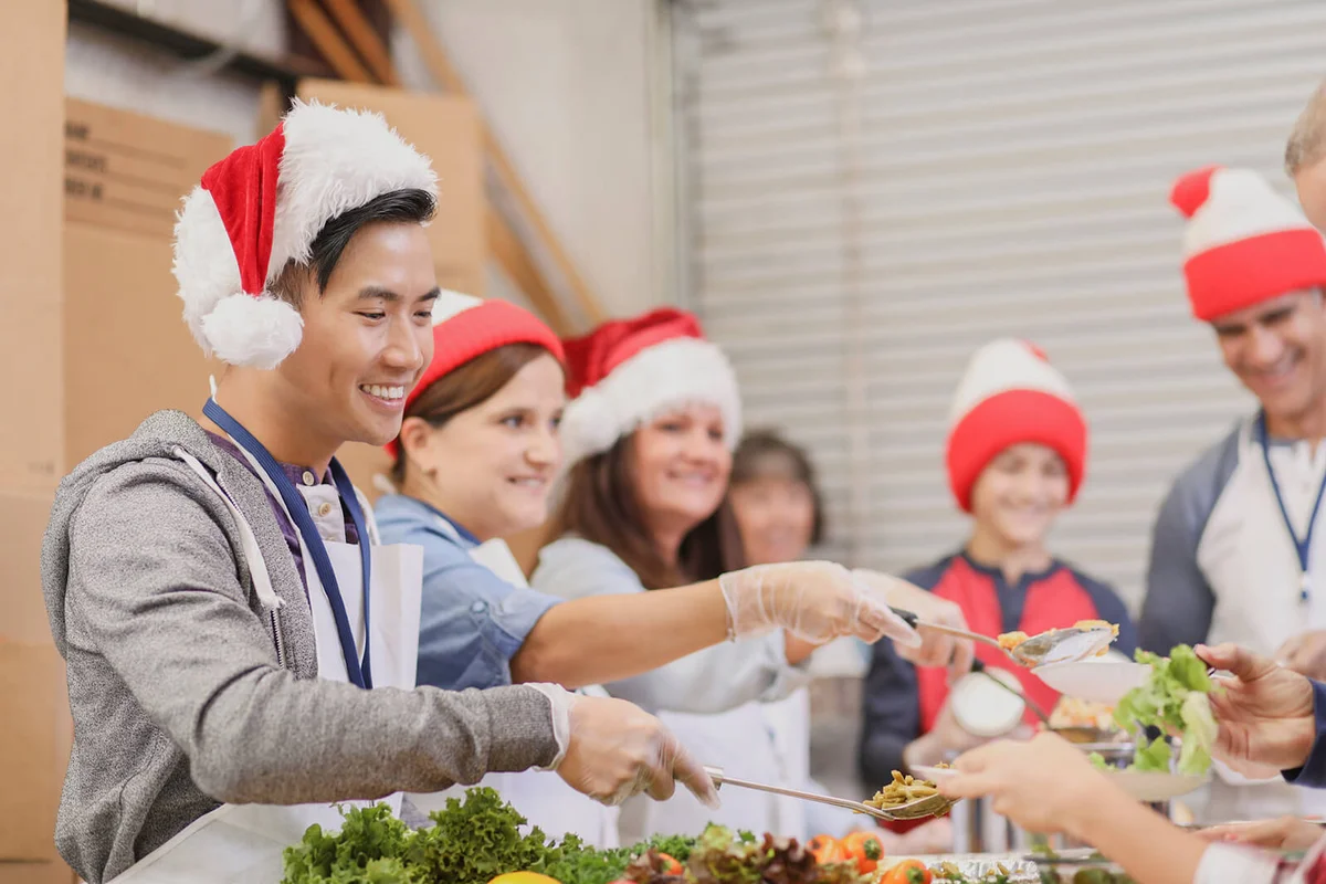 volunteers serves food at soup kitchen at Christmas