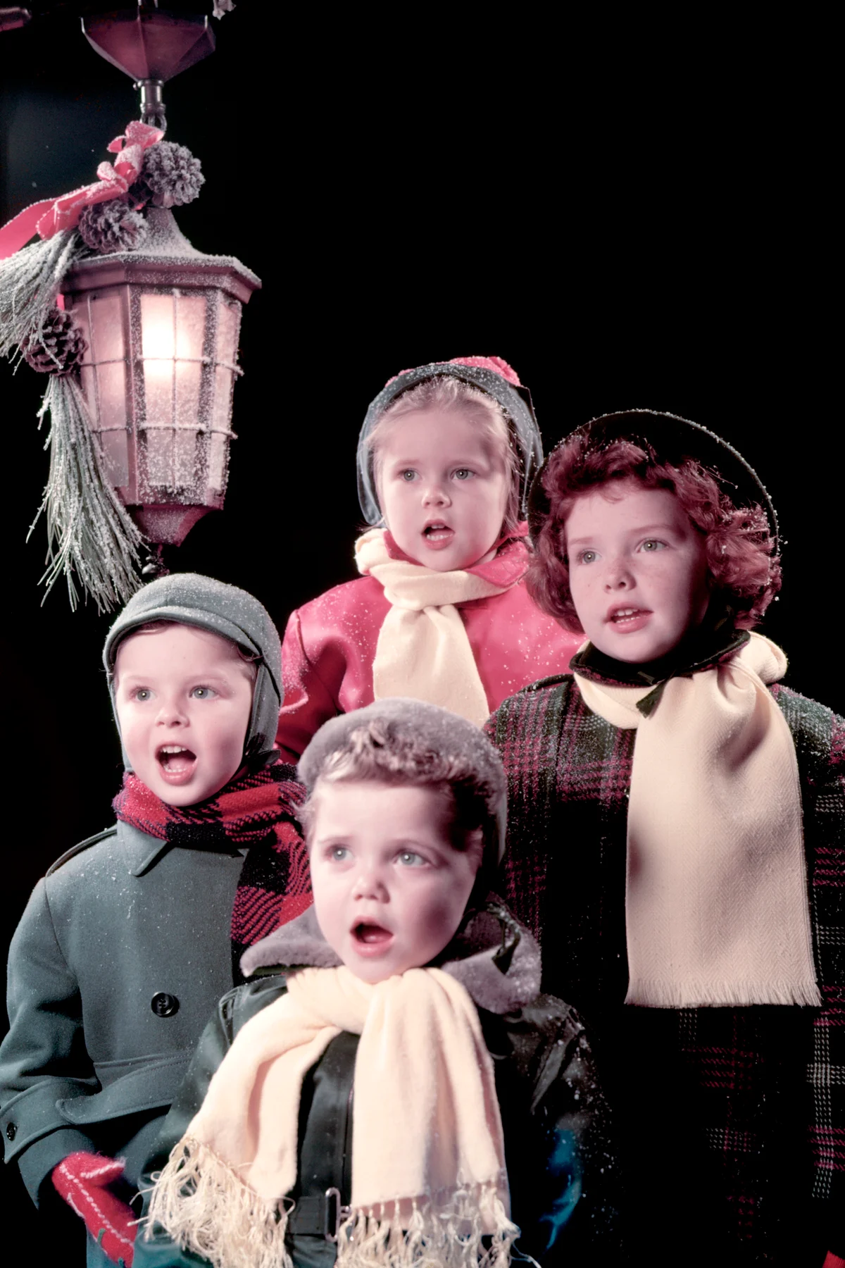 Four Children Sing Carols Under Lantern