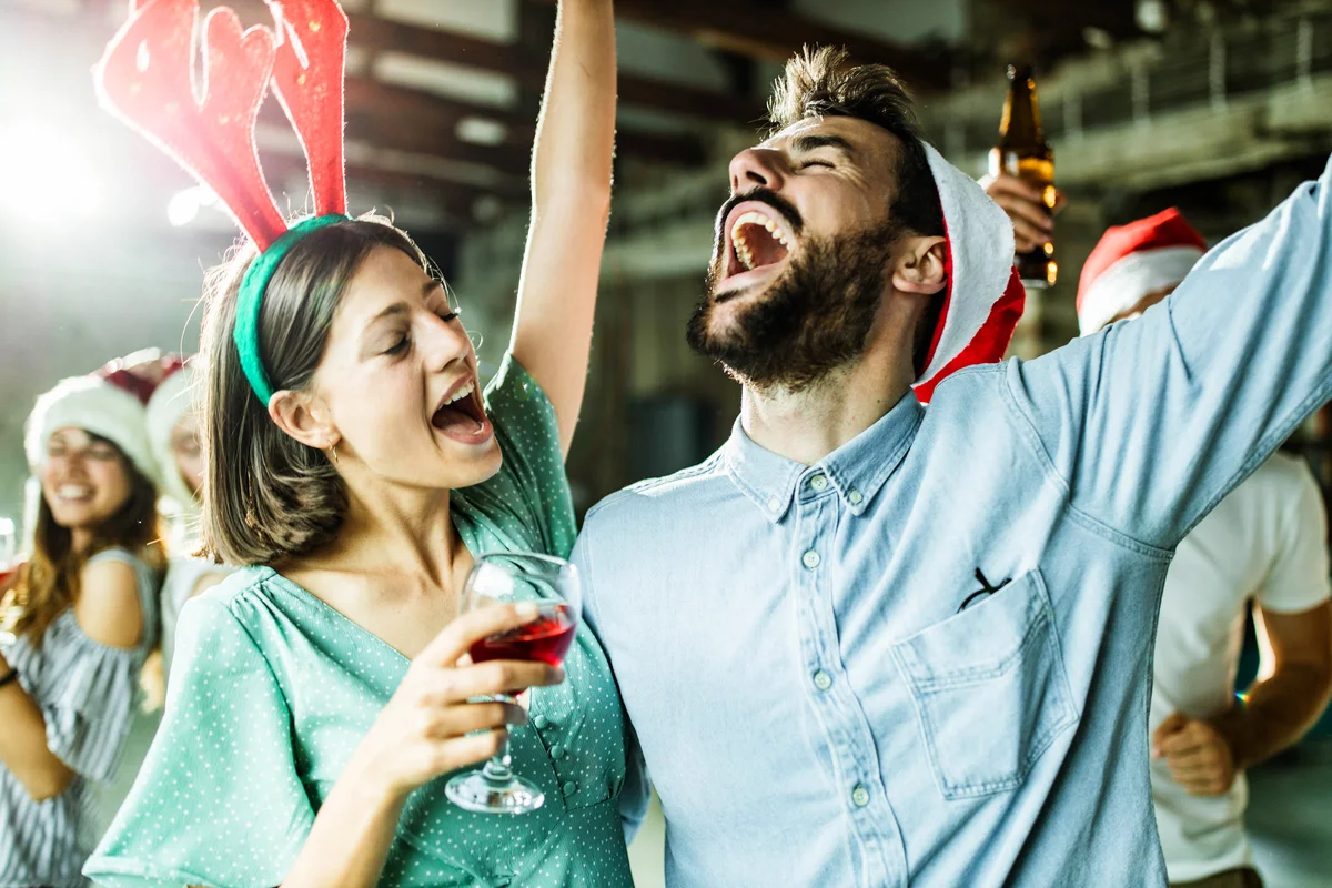 People having fun while singing on Christmas party