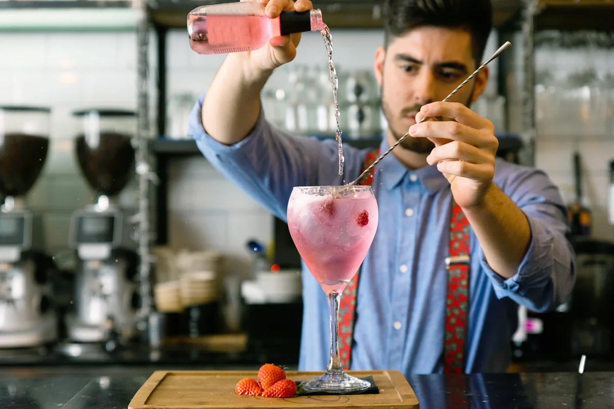 Bartender Preparing Drink In Bar