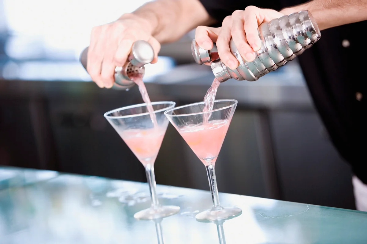 Bartender preparing a pink Martini