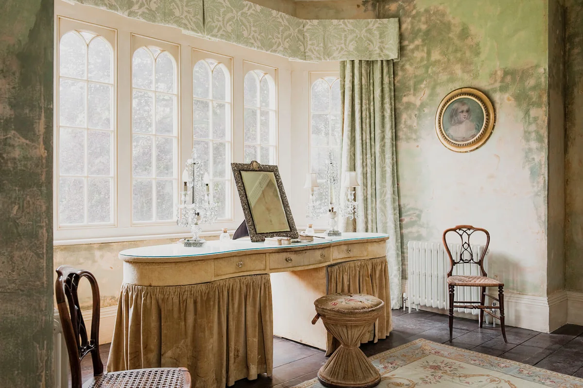 Dressing table and stool in window of Gloucestershire country estate home