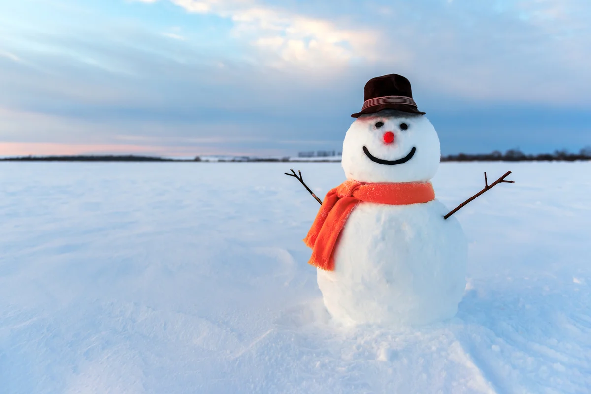 Snowman on sunset background