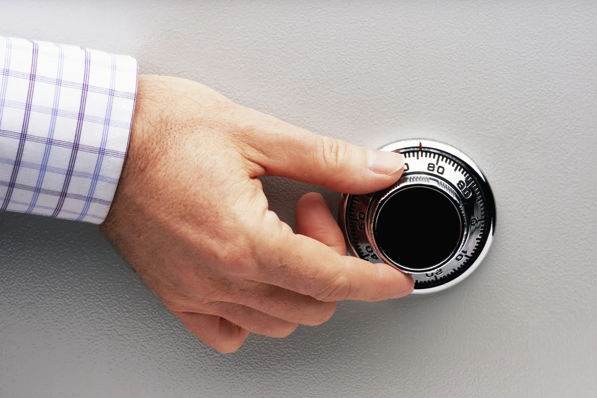 Man turning safe dial