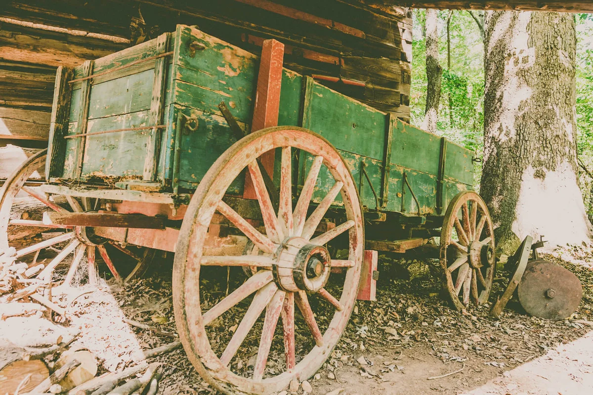 Rustic Wagon Beside Log Cabin