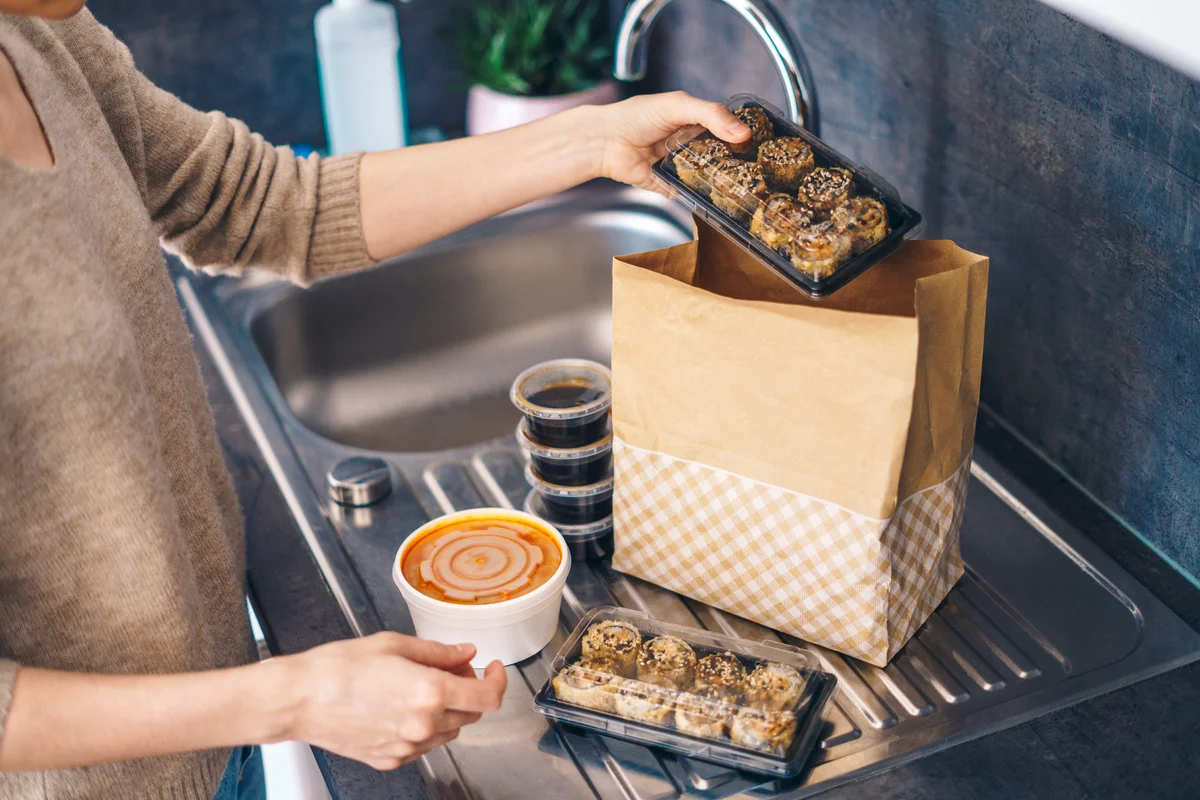 Woman unpacking takeaway food delivery