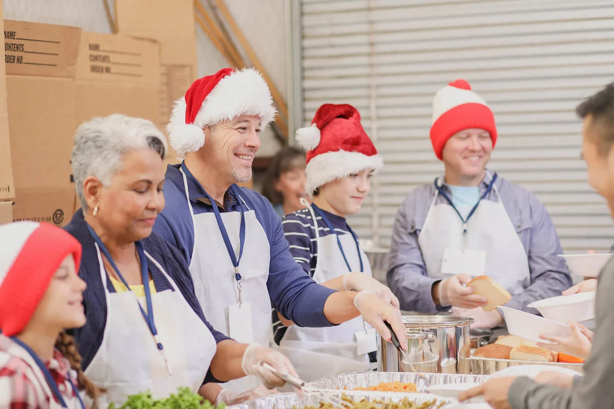 volunteers serves food at soup kitchen at Christmas