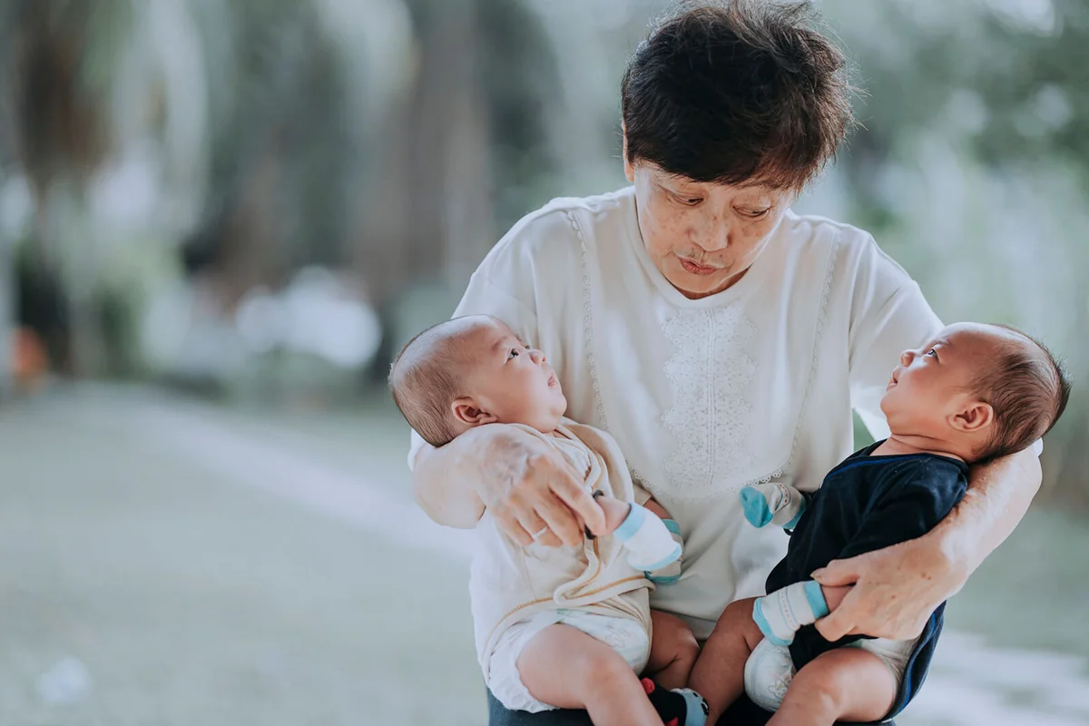 grandmother having bonding time together with her twin grandchildren