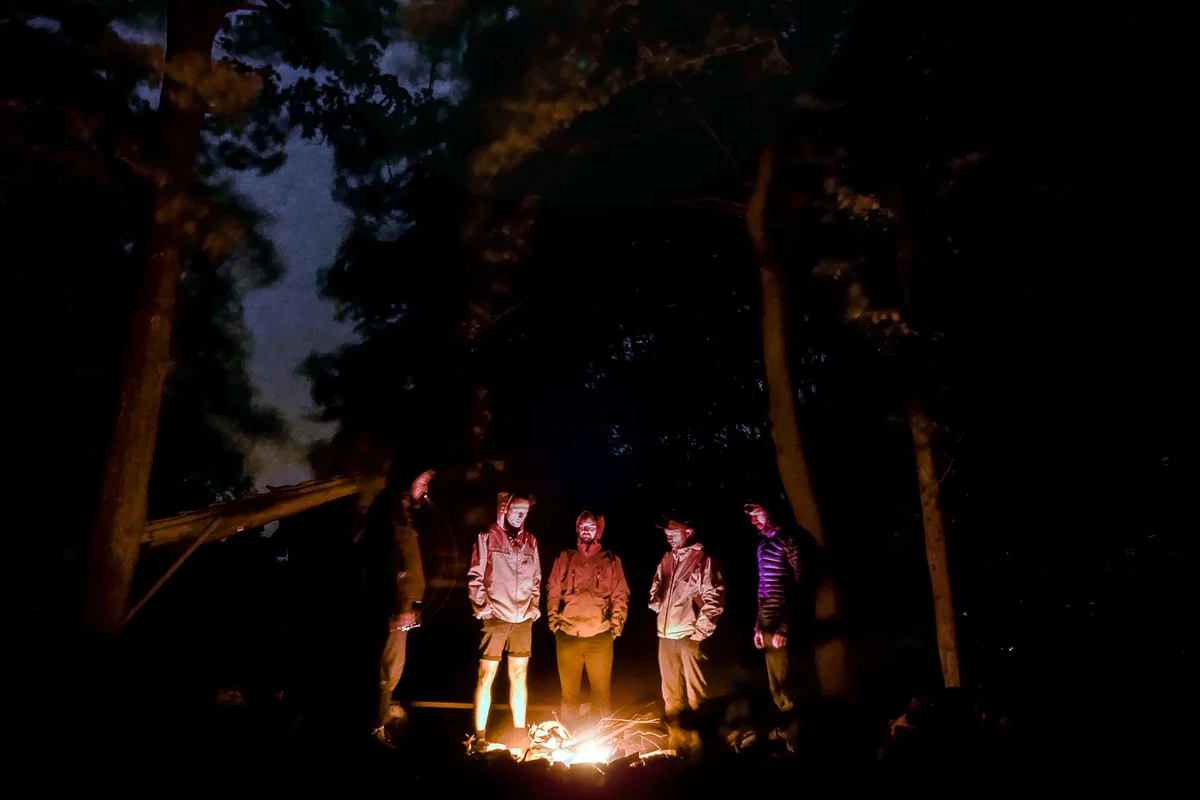 Group of friends around campfire