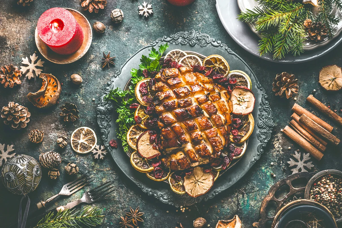 Christmas dinner table with roasted pork ham