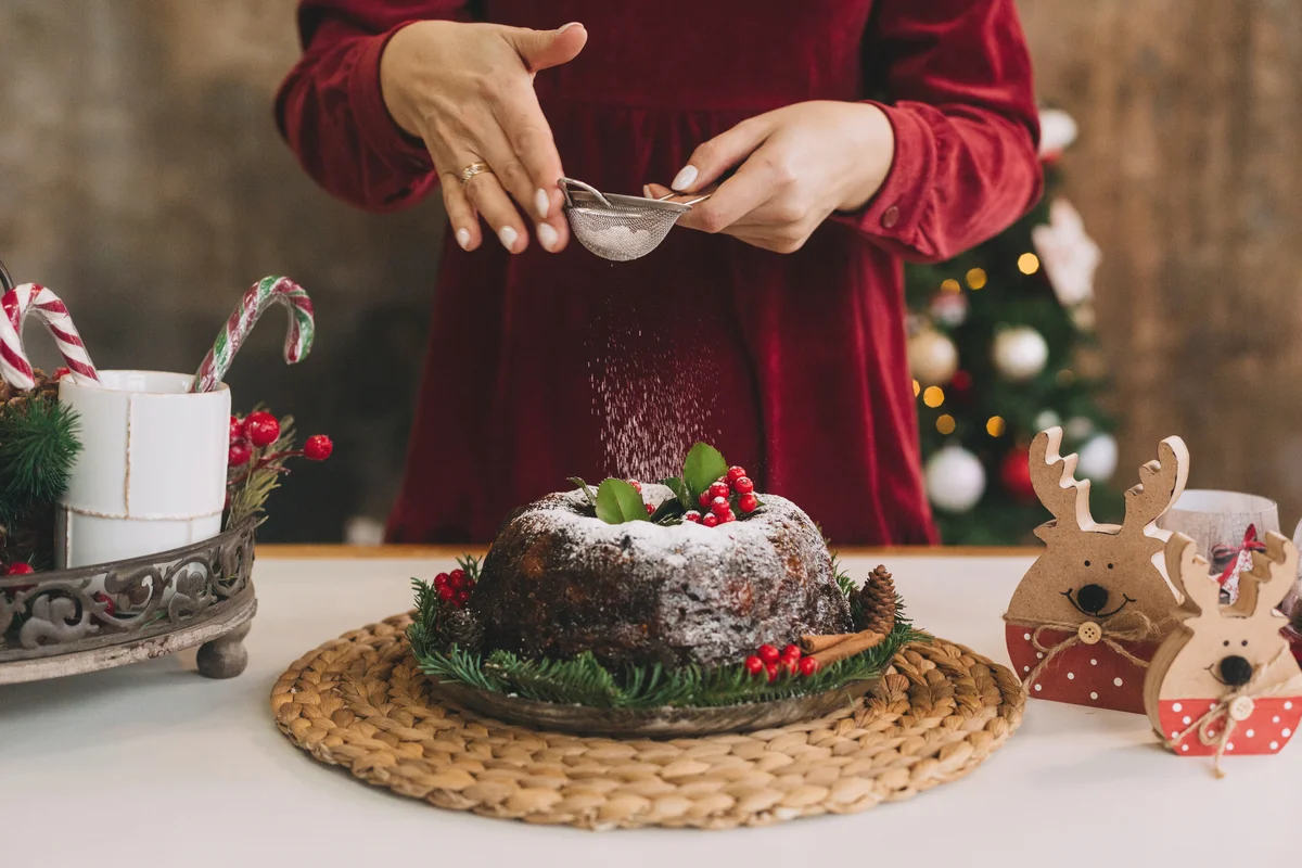 Woman Dusting Powder Sugar On Cake