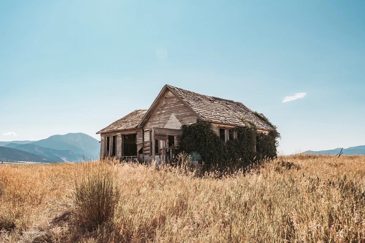 wooden barn on grass against sky
