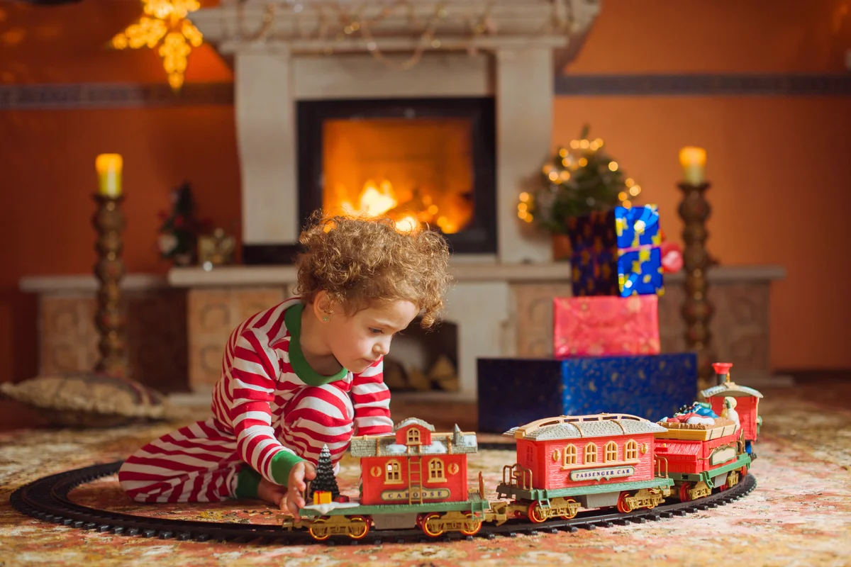 Girl playing with christmas train