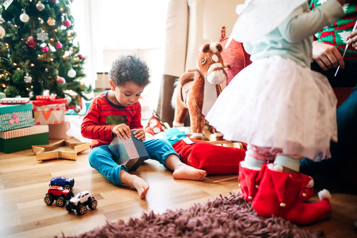Little Boy Opening a Gift at Christmas Time