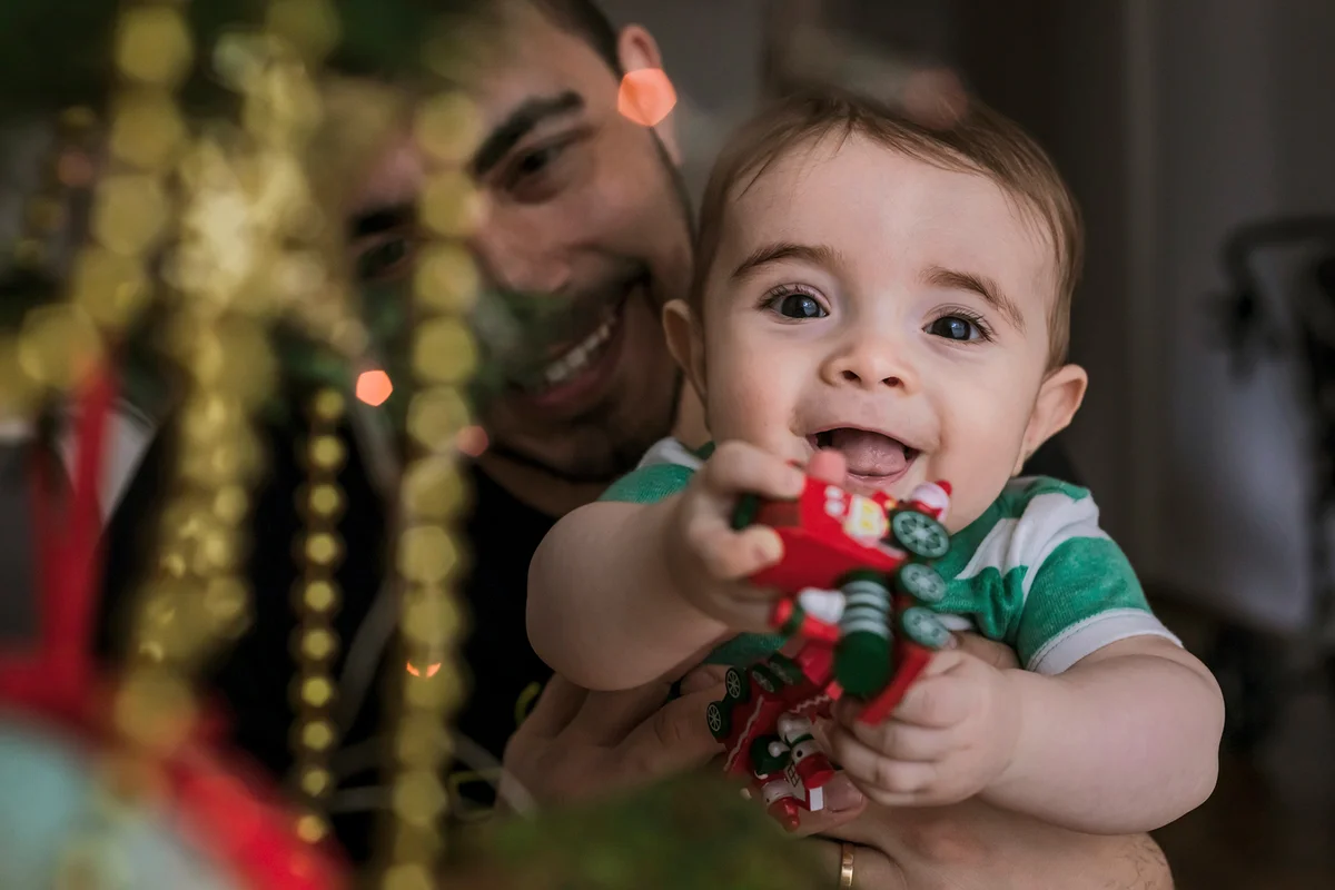 Baby boy beside Christmas tree