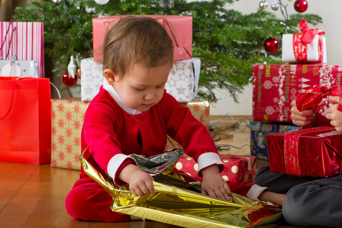 Baby unwrapping Christmas present