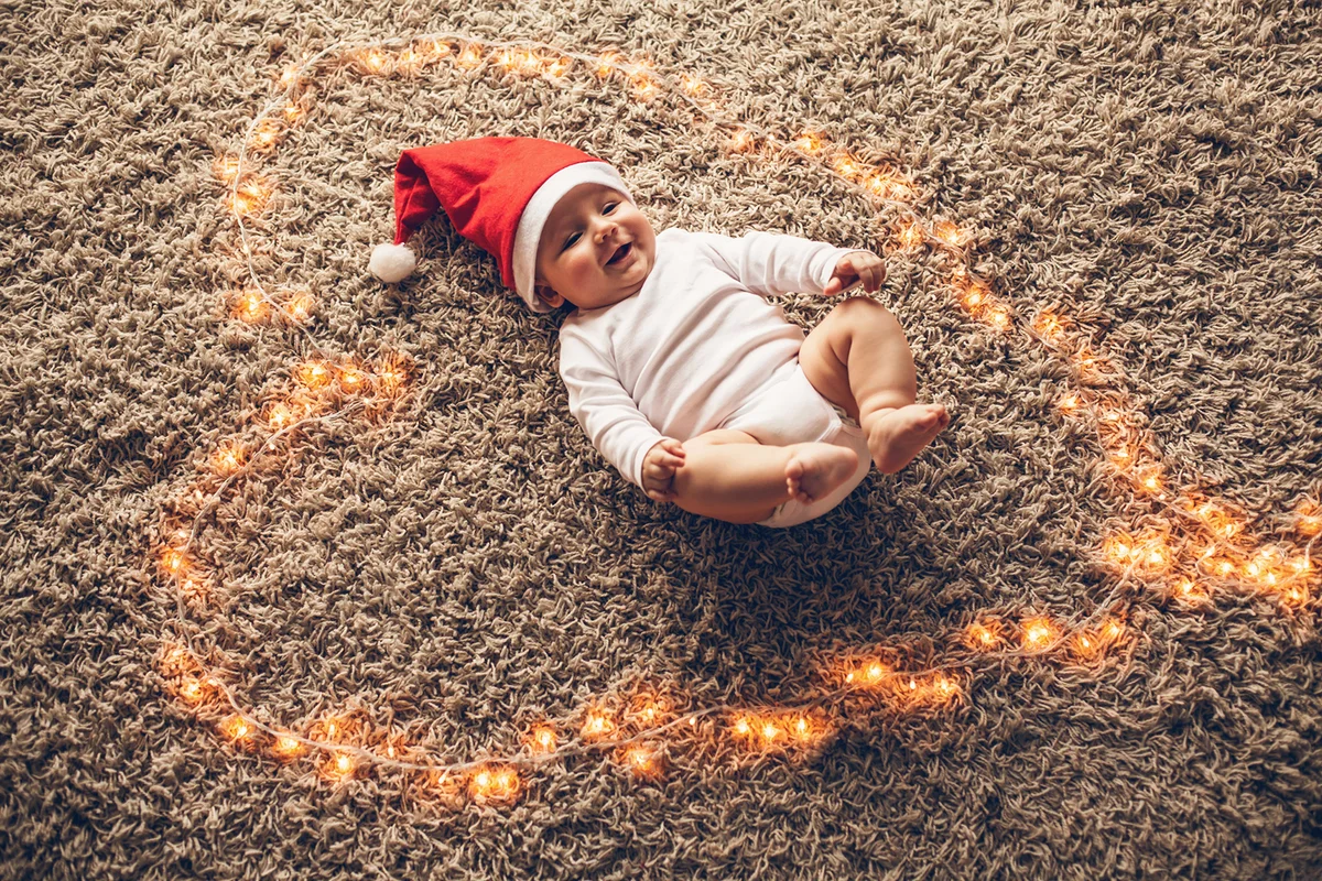 Baby surrounded with Christmas lights