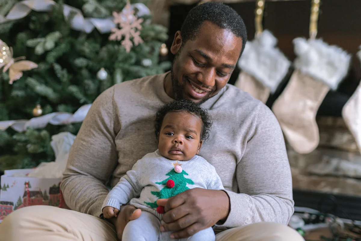 A dad hugs his newborn daughter on Christmas Day