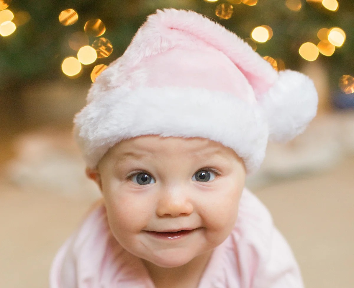 Baby girl in pink Santa hat