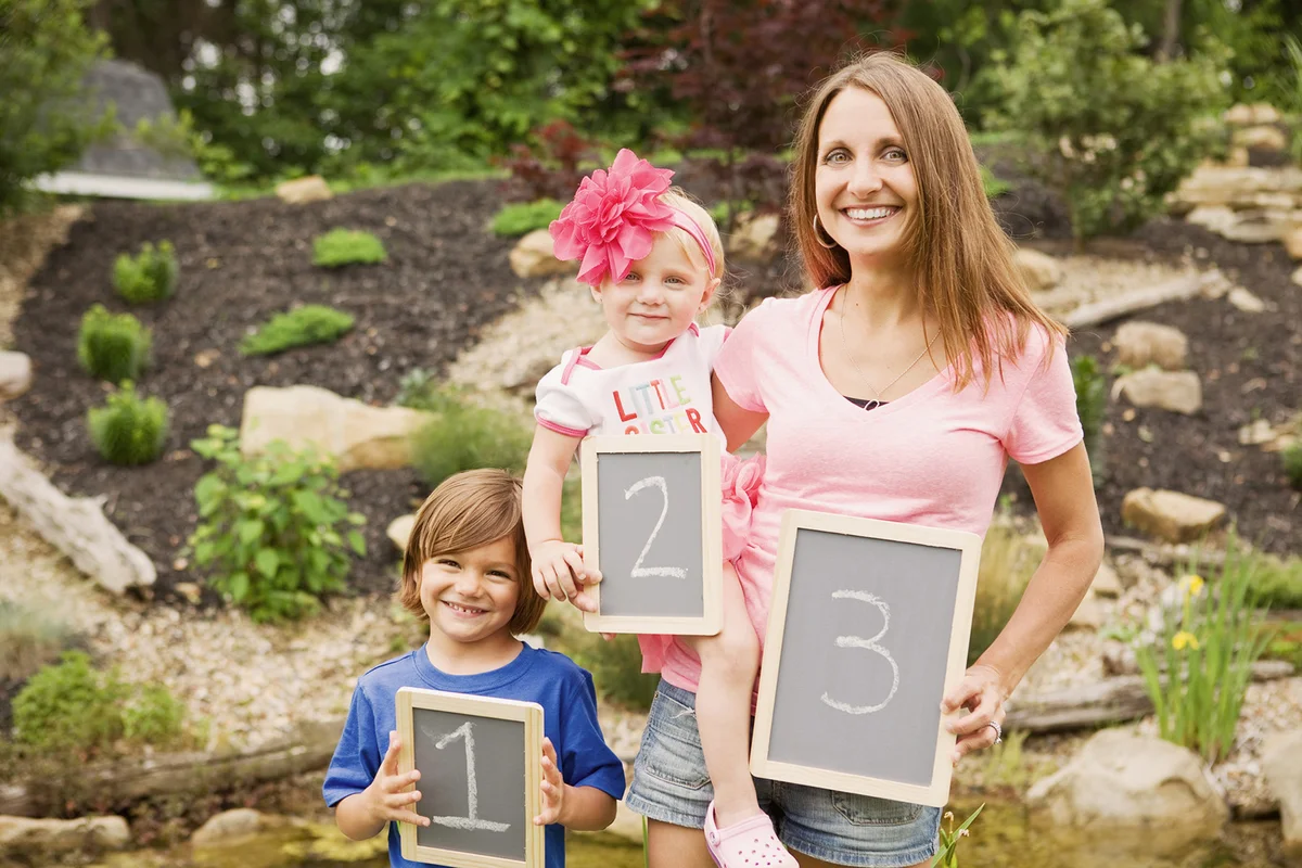 A mom and her two kids showing the birth order including a 3rd one on the way