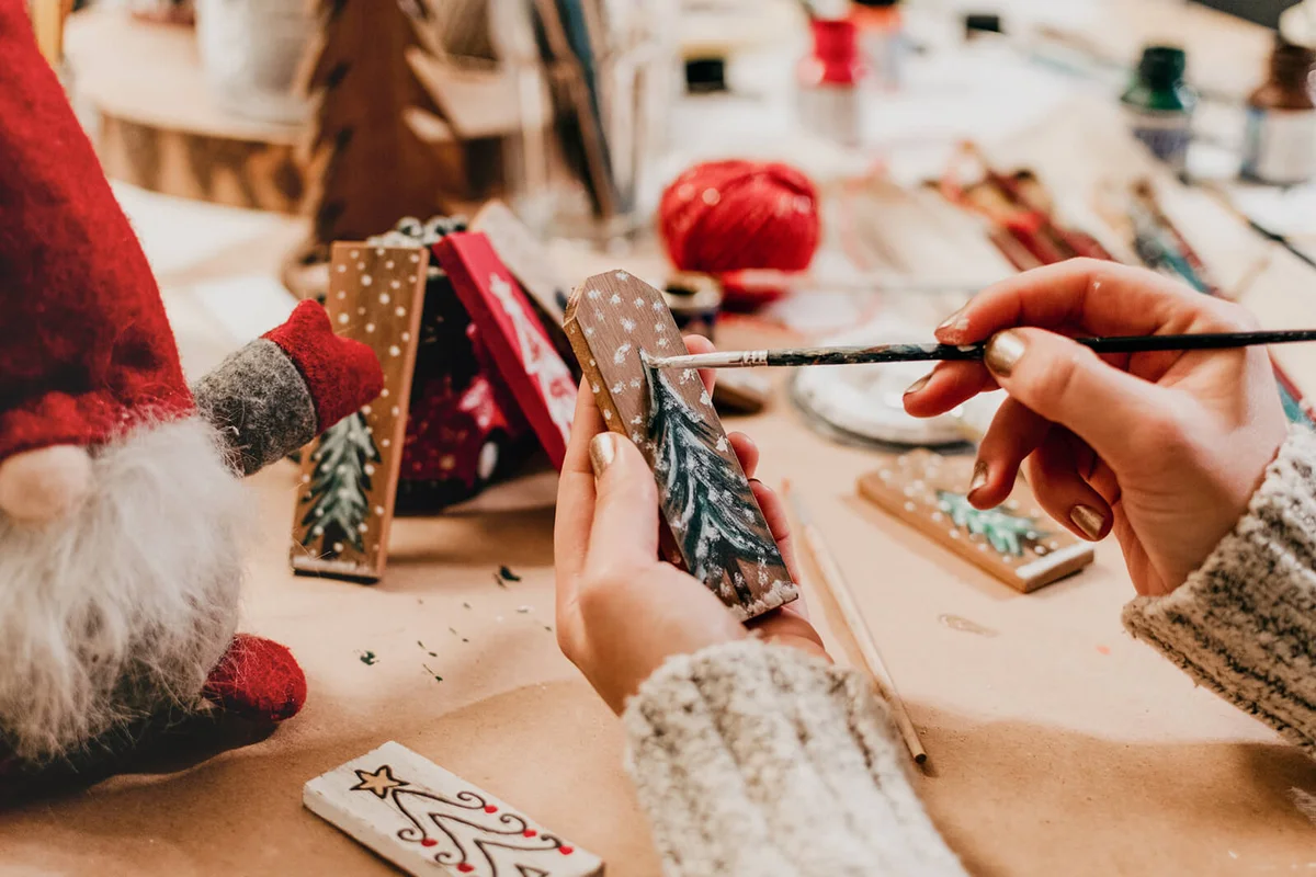 Hand Holding Paintbrush, Crafting Christmas Ornaments