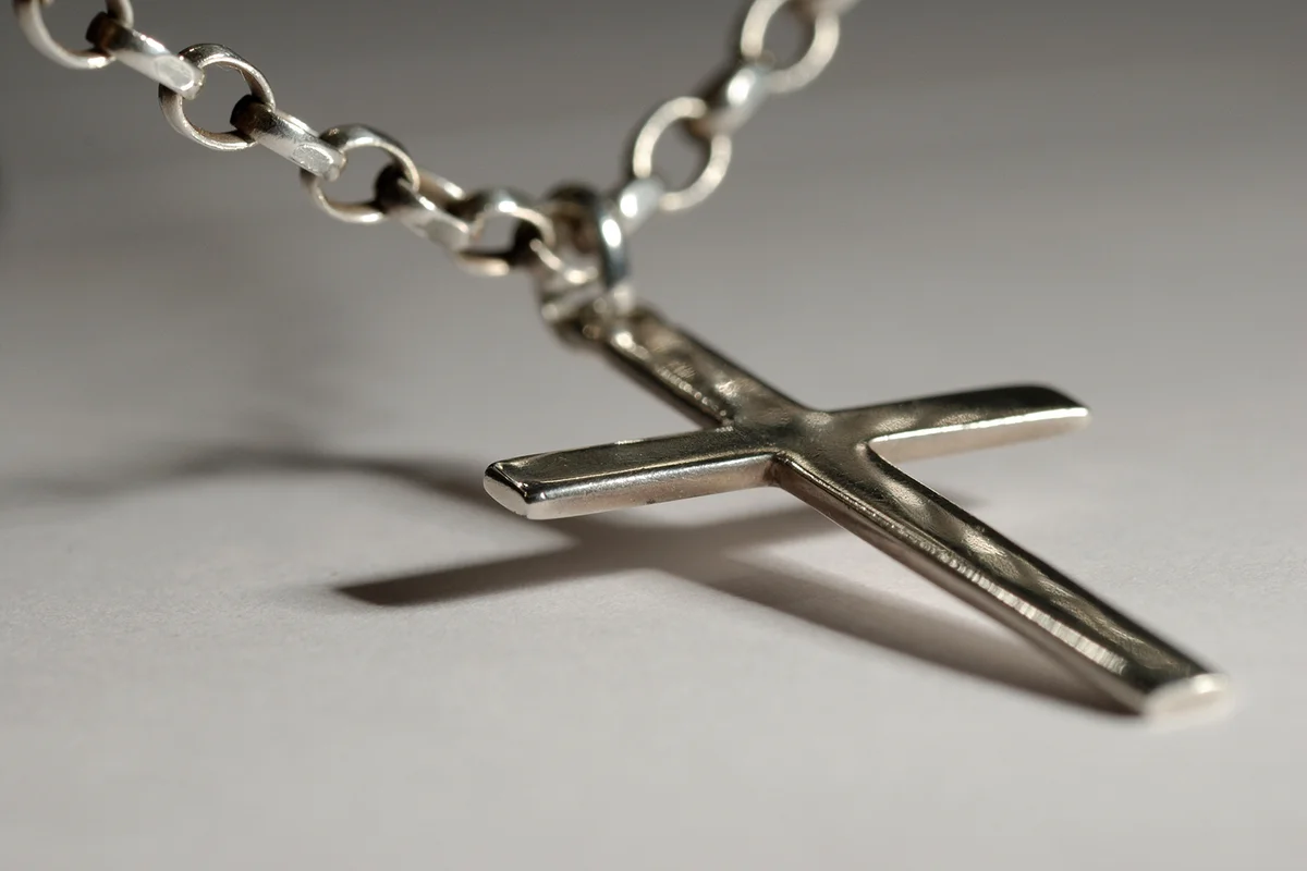 Silver crucifix on necklace chain