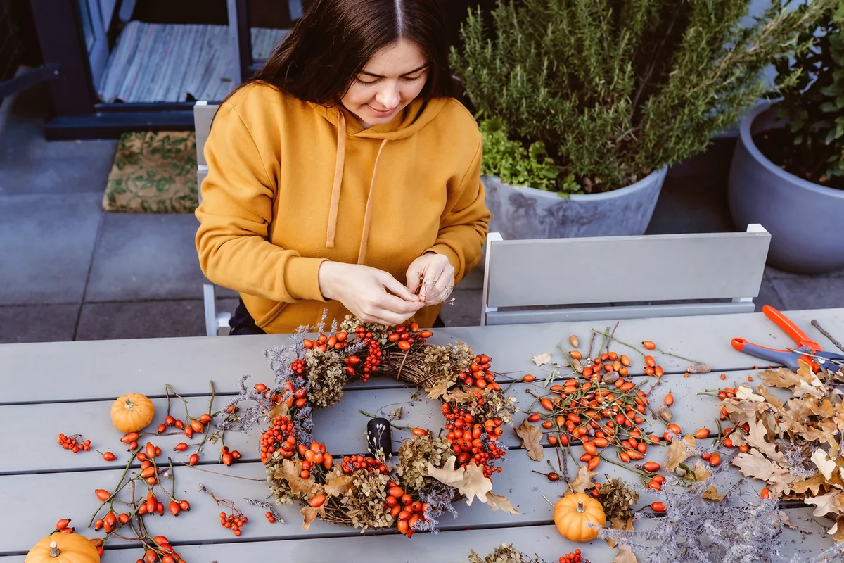 Woman making autumn wreath