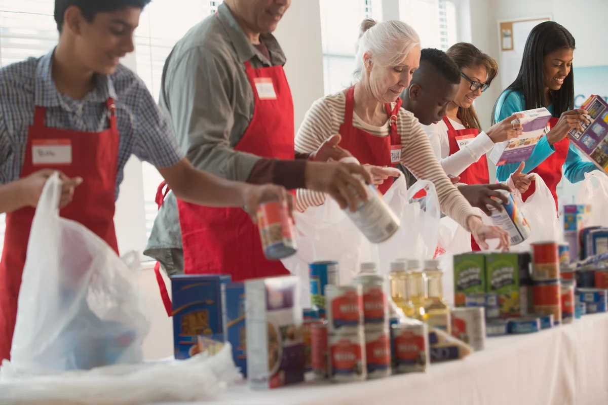 Volunteers packing canned goods at food drive
