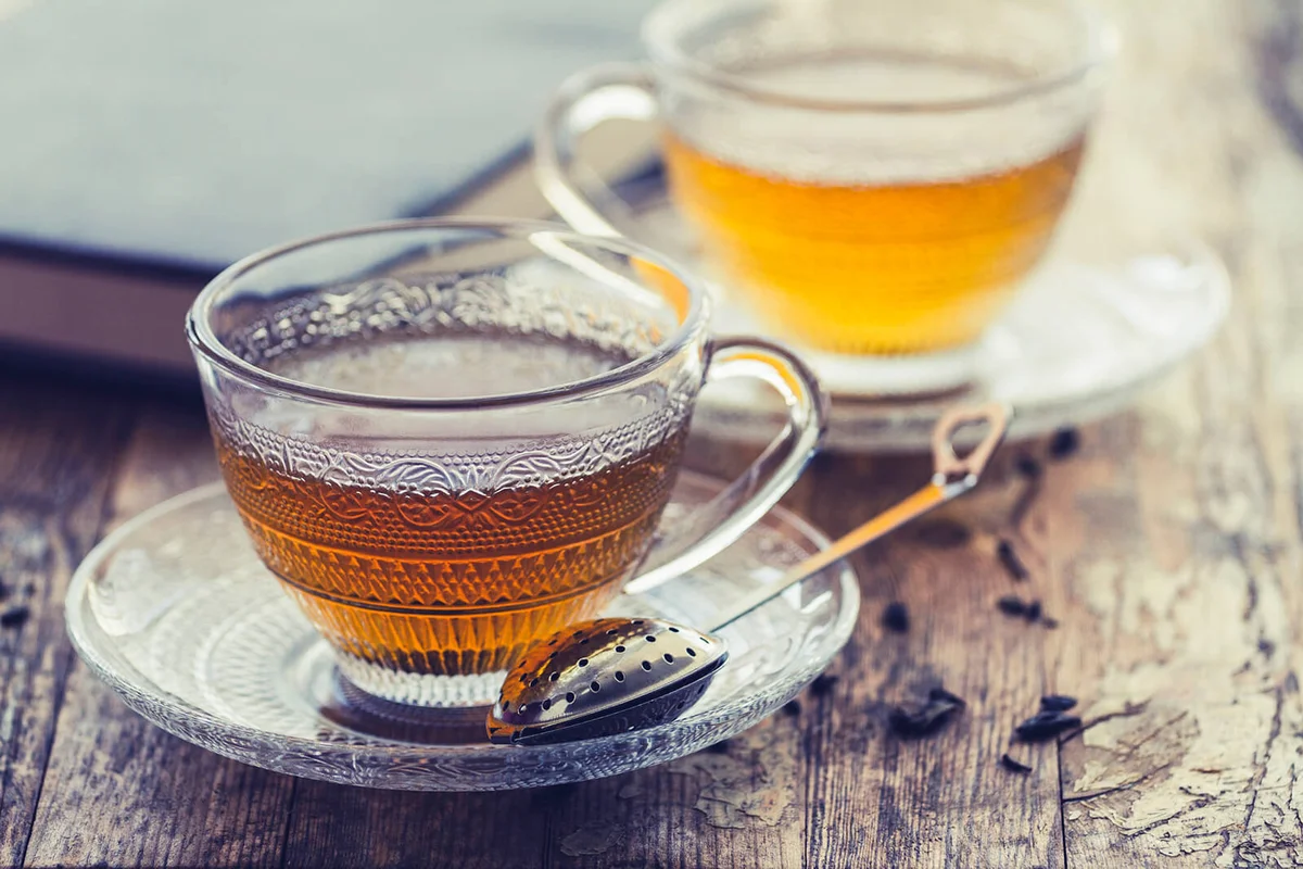 Cup of green tea on a vintage rustic wood blurry