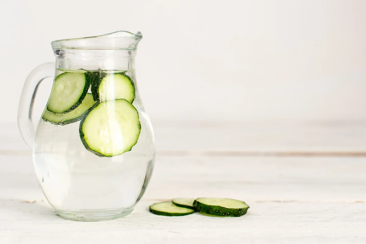 cucumber falling into glass of water