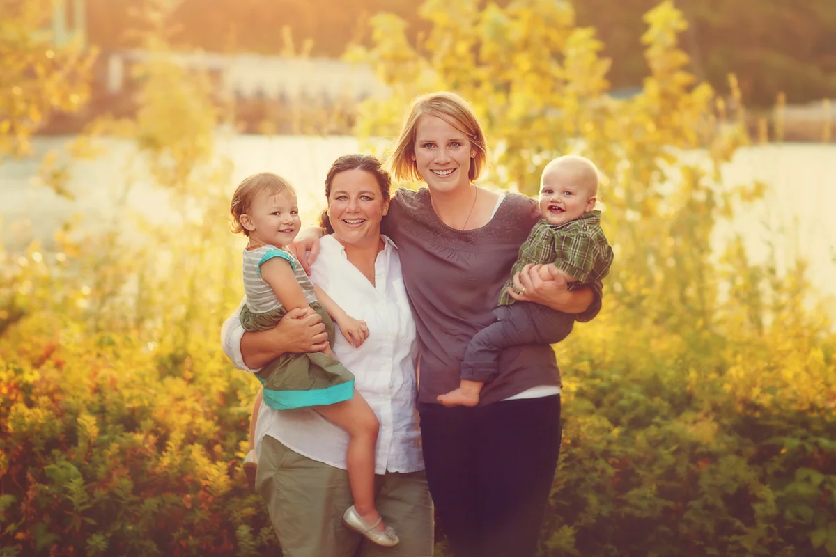 Happy couple holding their children